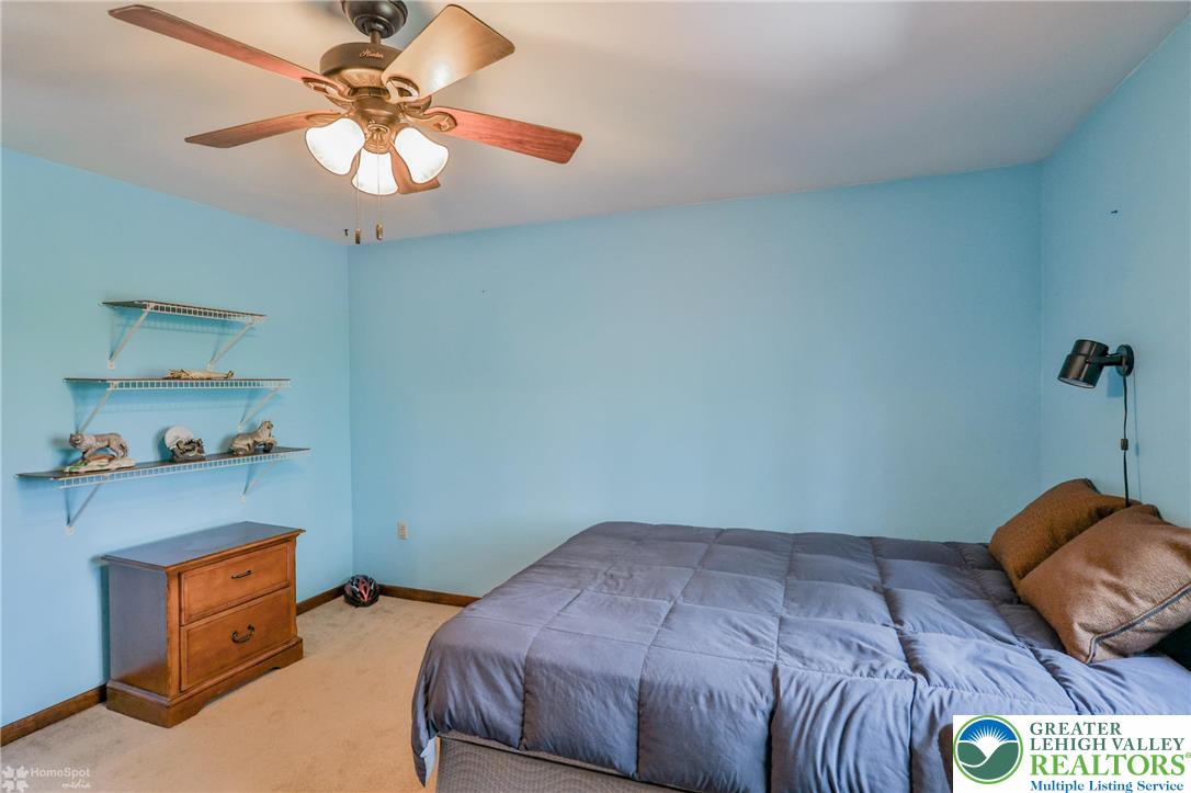 1208 Rone Drive Wind Gap, PA 18091 - Photo 44 of 78 a bedroom with a bed and a chandelier