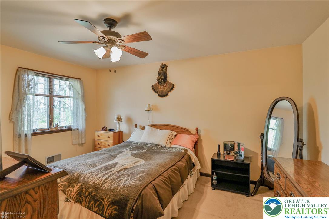 1208 Rone Drive Wind Gap, PA 18091 - Photo 49 of 78 a bedroom with a bed and dresser with wooden floor