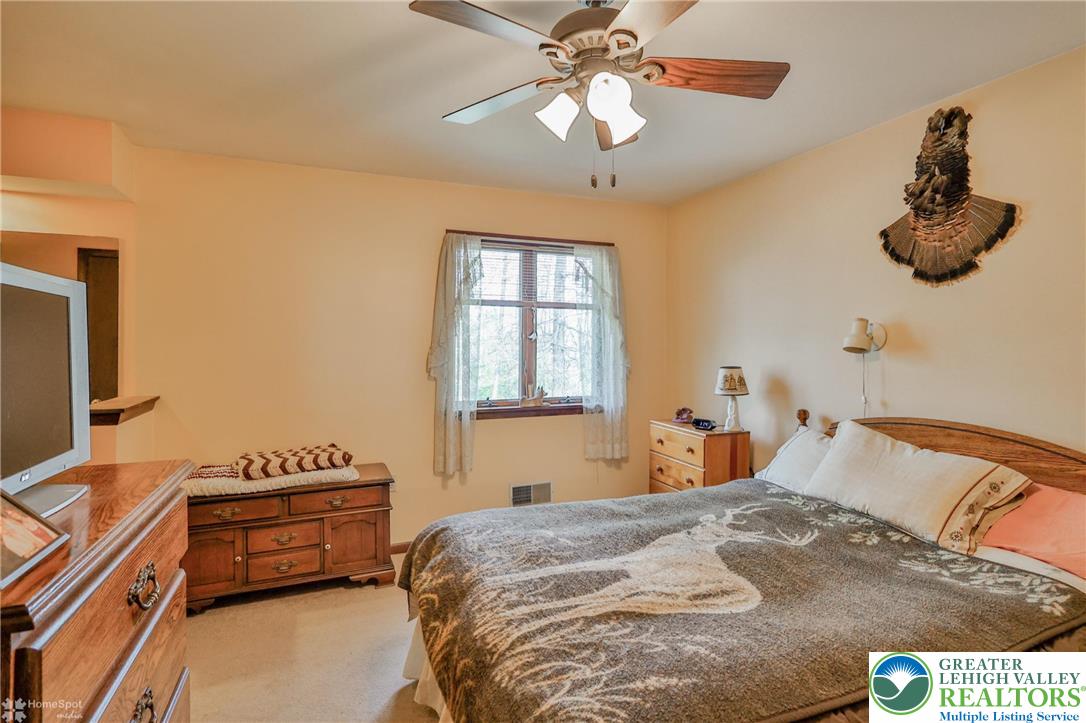 1208 Rone Drive Wind Gap, PA 18091 - Photo 50 of 78 a bedroom with a bed and a chandelier