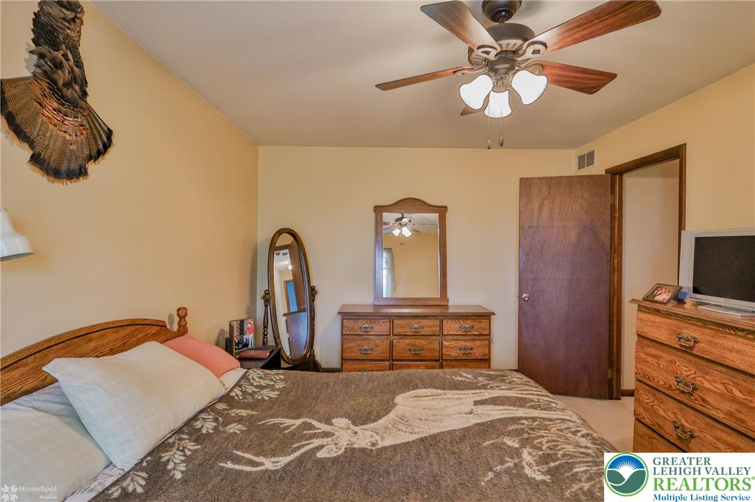1208 Rone Drive Wind Gap, PA 18091 - Photo 54 of 78 a bedroom with a bed and a flat tv screen on dresser