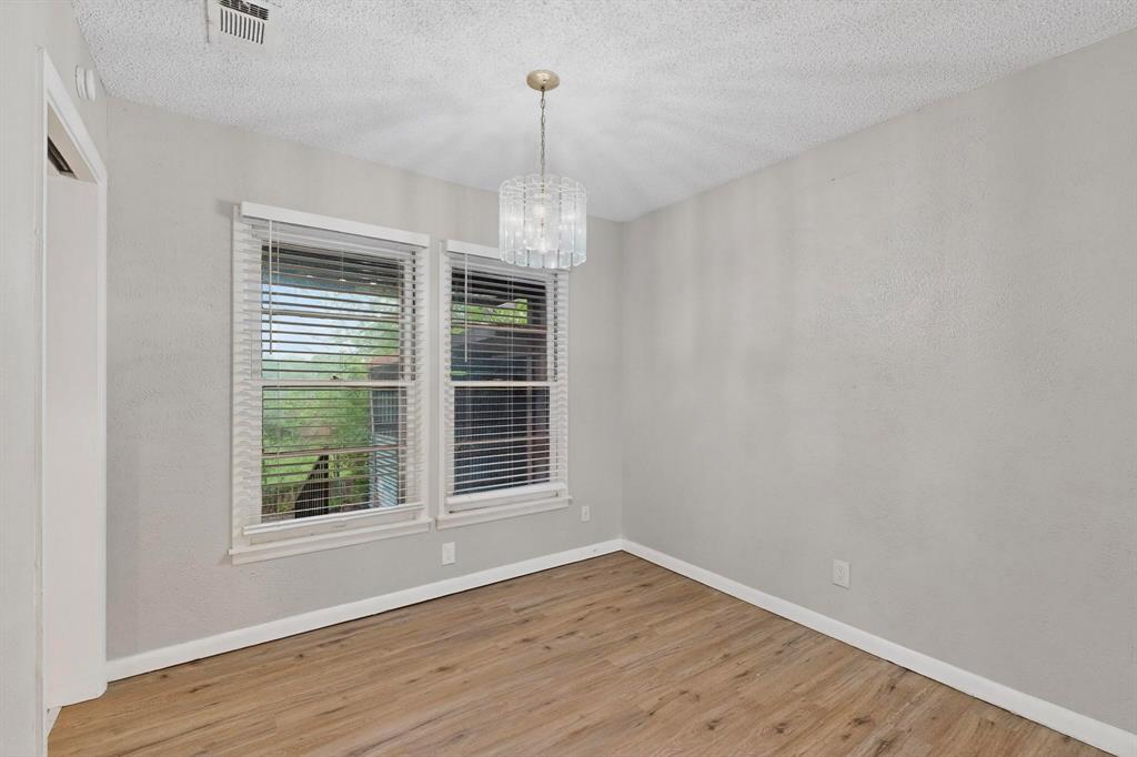 4508 Rutland Avenue Fort Worth, TX 76133 - Photo 11 of 36 an empty room with wooden floor and windows