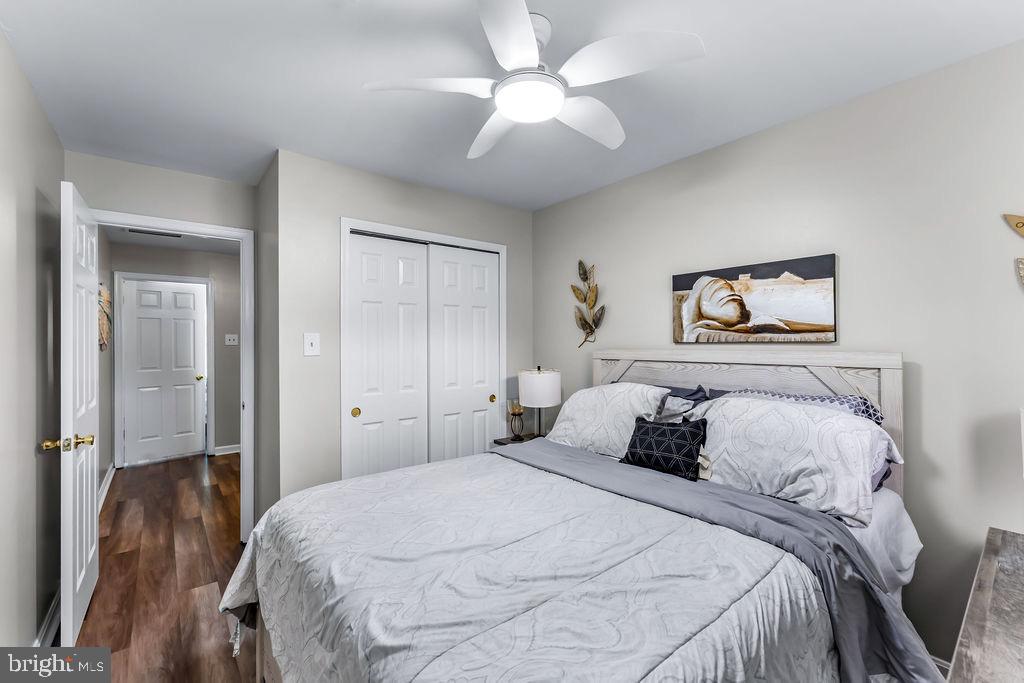 11409 Hermosa Drive Laurel, MD 20708 - Photo 21 of 28 a bedroom with a large bed and a chandelier