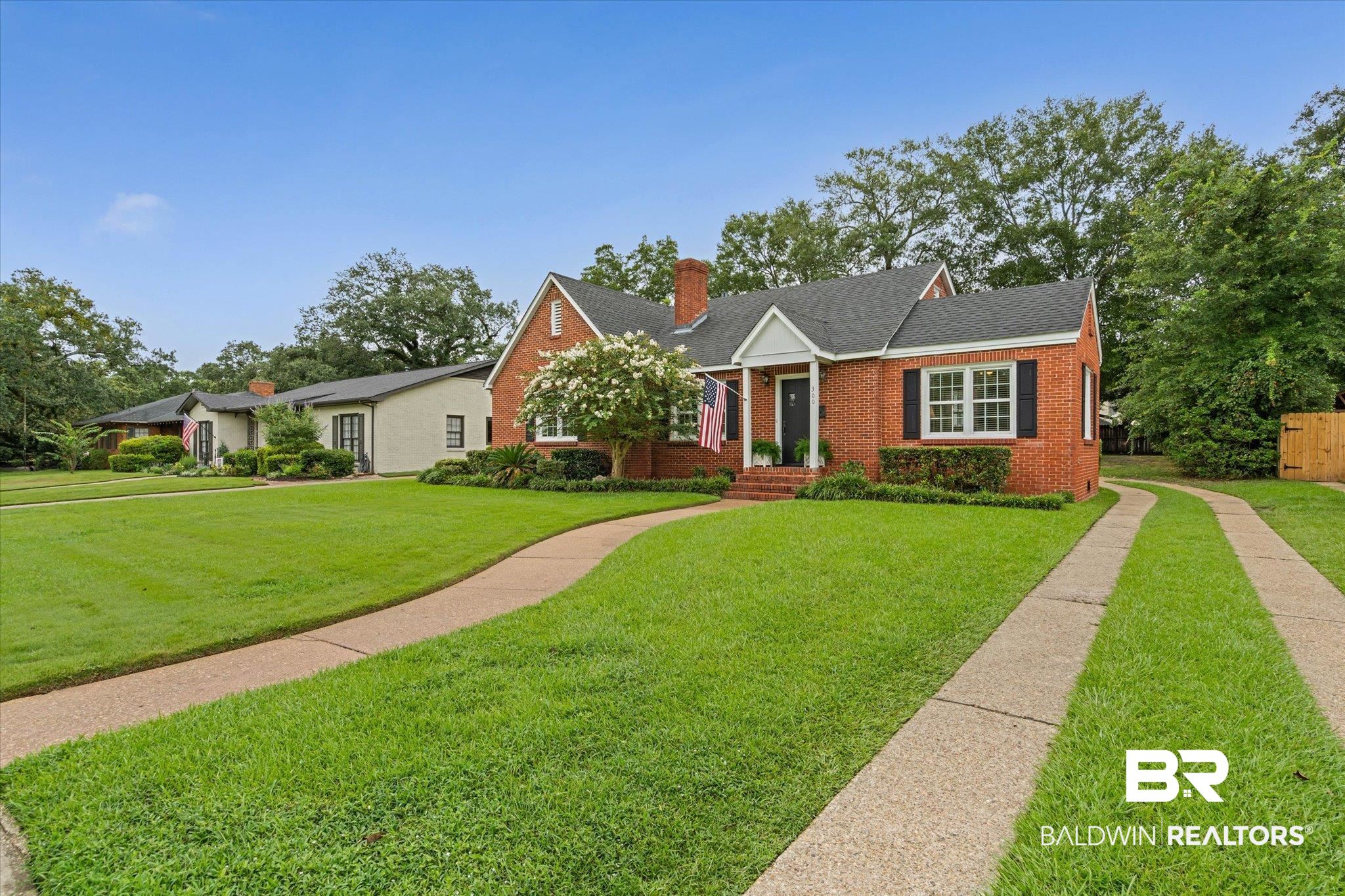 300 Woodlands Avenue Mobile, AL 36607 - Photo 22 of 23 View of front facade featuring brick siding, a chimney, and roof with shingles