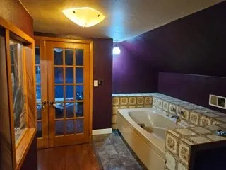 a view of a room with wooden floor