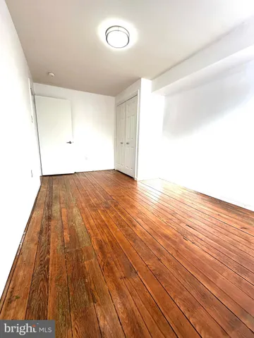 an empty room with wooden floor