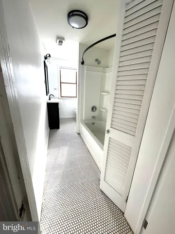 a bathroom with a glass door shower and a sink