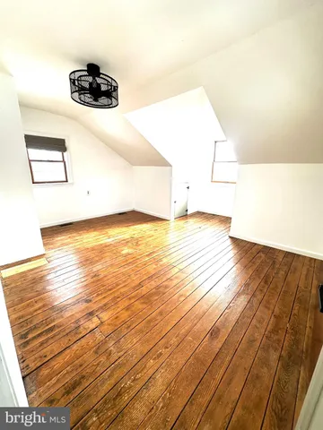 a view of a room with wooden floor