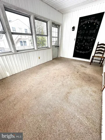 an empty room with large windows