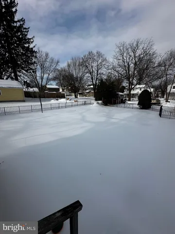 a view of road with a cars parked on the roadside