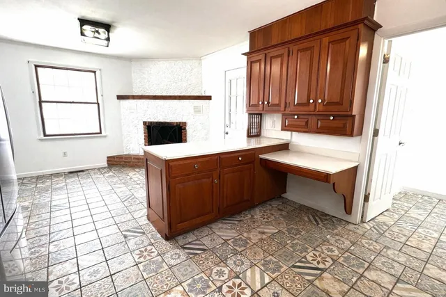 a kitchen with a sink a stove cabinets and counter space