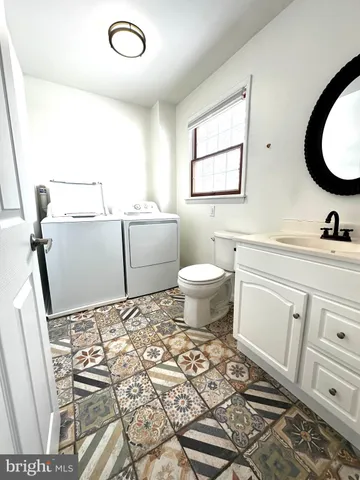a bathroom with a sink toilet and mirror
