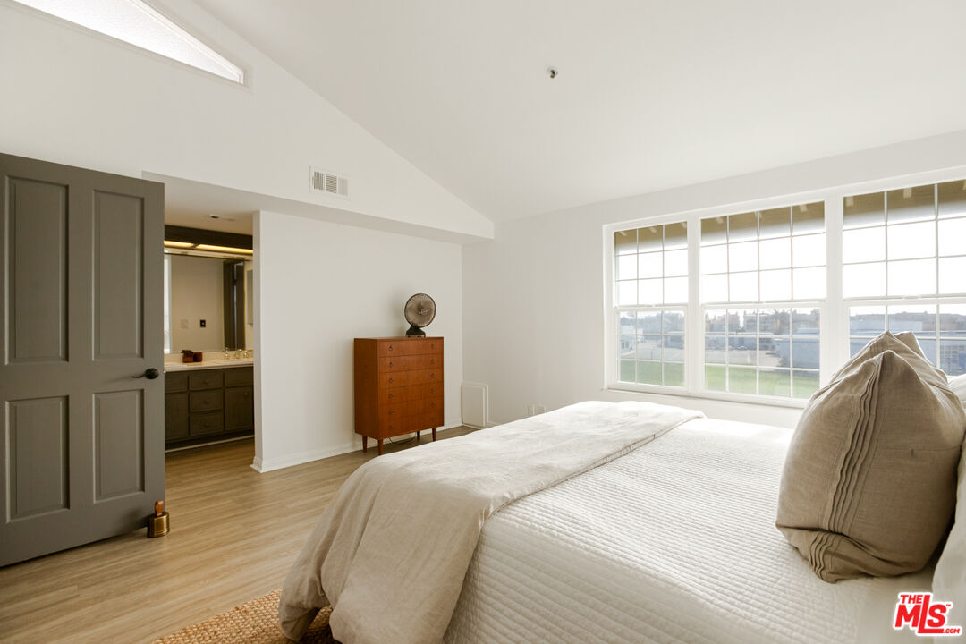 2845 Harbor Boulevard Oxnard, CA 93035 - Photo 17 of 47 a bedroom with a bed and wooden floor
