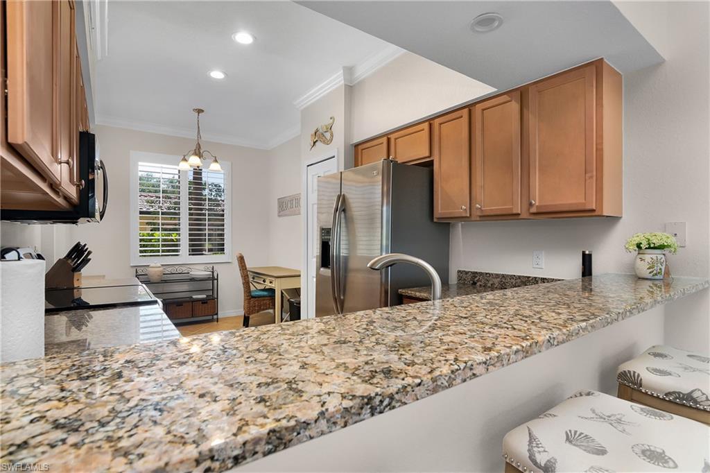 9719 Acqua Court, Unit 214 Naples, FL 34113 - Photo 11 of 50 a kitchen with sink refrigerator and stove