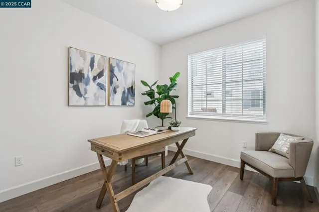 a view of a workspace with furniture and a potted plant