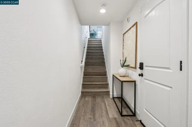 a view of entryway and hall with wooden floor