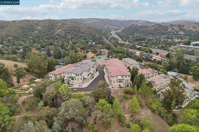 an aerial view of residential house with an outdoor space and mountain view
