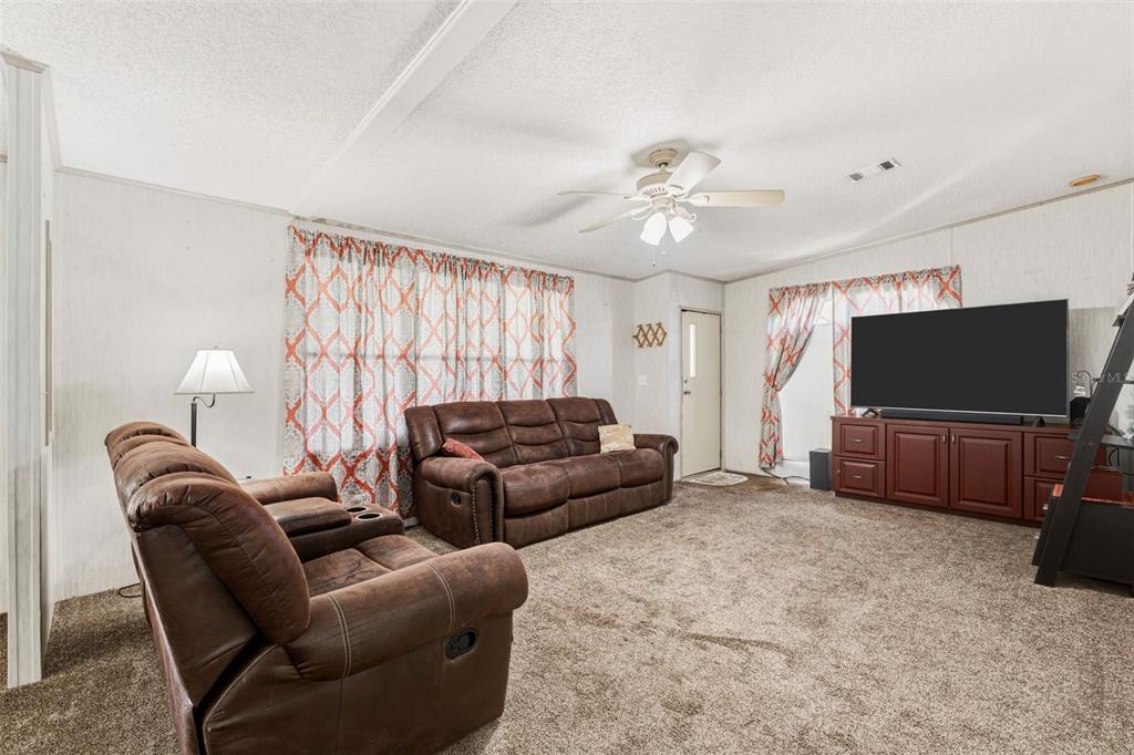 1586 Grapefruit Street Arcadia, FL 34266 - Photo 13 of 40 a living room with furniture and a flat screen tv