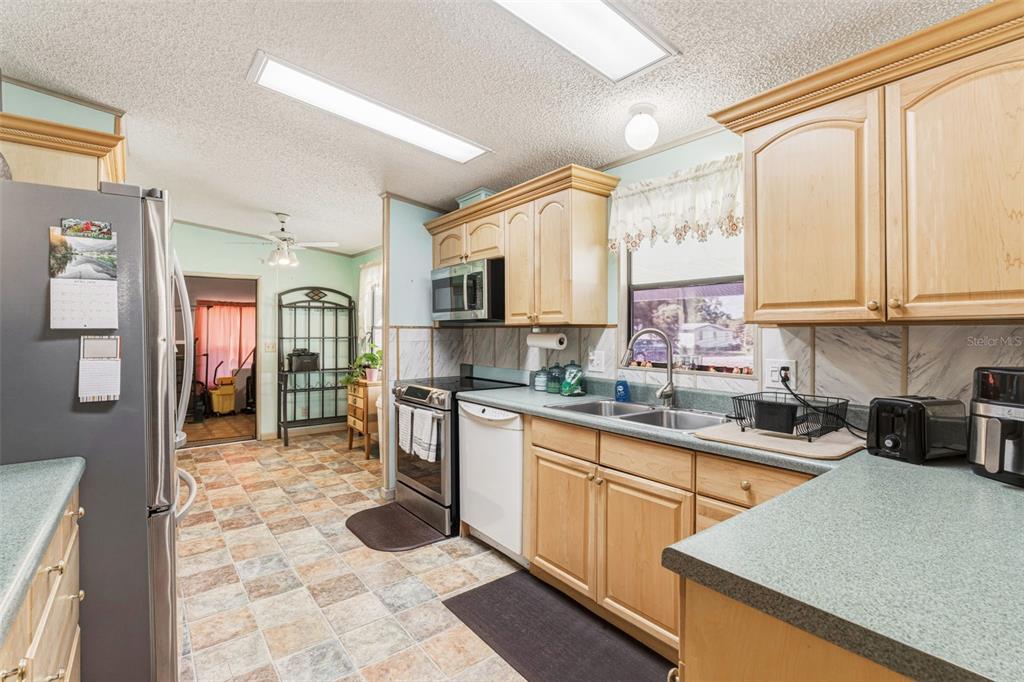 1586 Grapefruit Street Arcadia, FL 34266 - Photo 16 of 40 a kitchen with stainless steel appliances granite countertop a stove top oven a sink a counter top space and cabinets