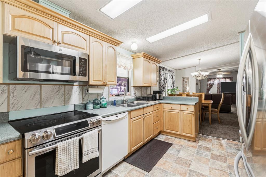 1586 Grapefruit Street Arcadia, FL 34266 - Photo 17 of 40 a kitchen with stainless steel appliances granite countertop a stove a sink and a microwave