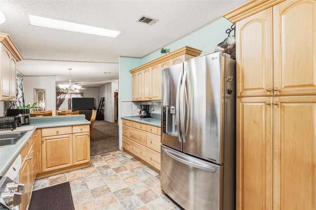 1586 Grapefruit Street Arcadia, FL 34266 - Photo 18 of 40 a kitchen with stainless steel appliances granite countertop a refrigerator a oven and white cabinets