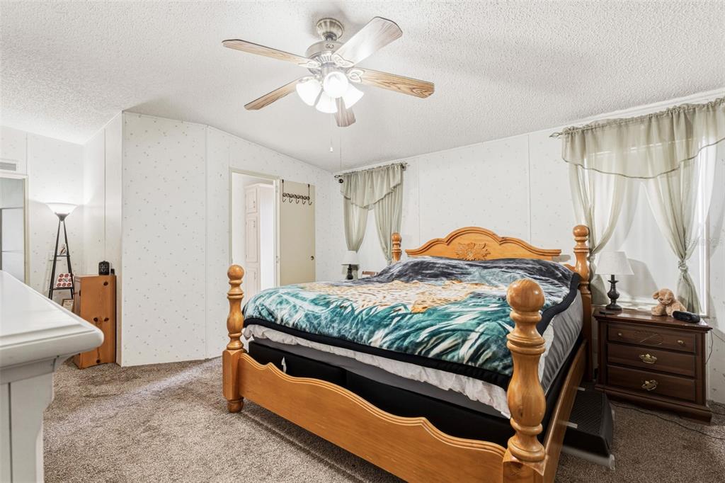 1586 Grapefruit Street Arcadia, FL 34266 - Photo 23 of 40 a bedroom with a bed and a chandelier