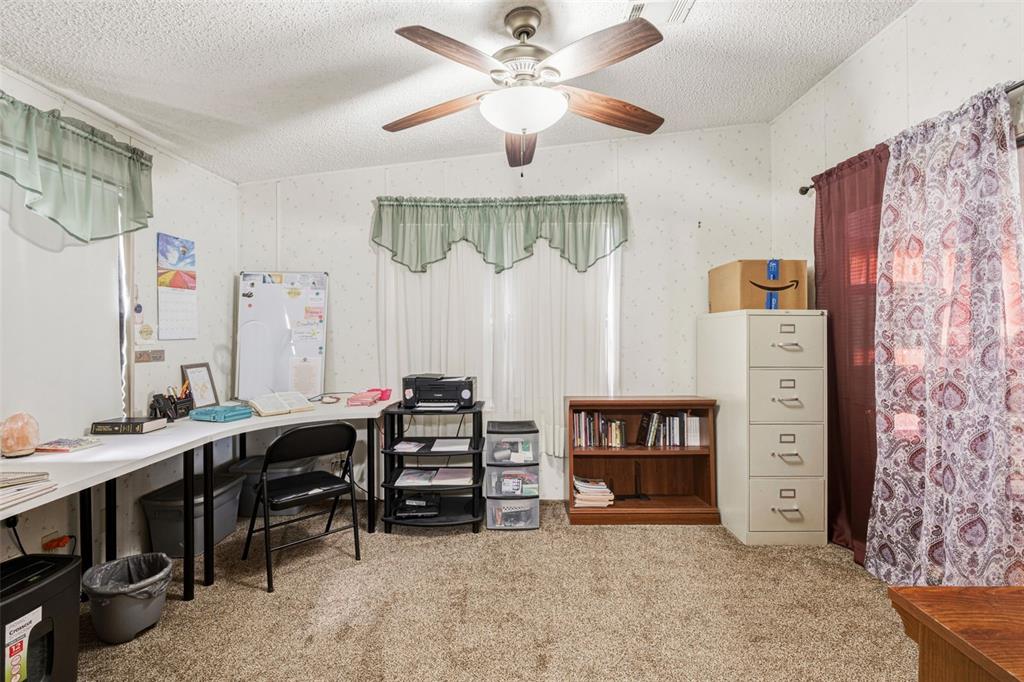 1586 Grapefruit Street Arcadia, FL 34266 - Photo 26 of 40 a view of a workspace with furniture and a livingroom