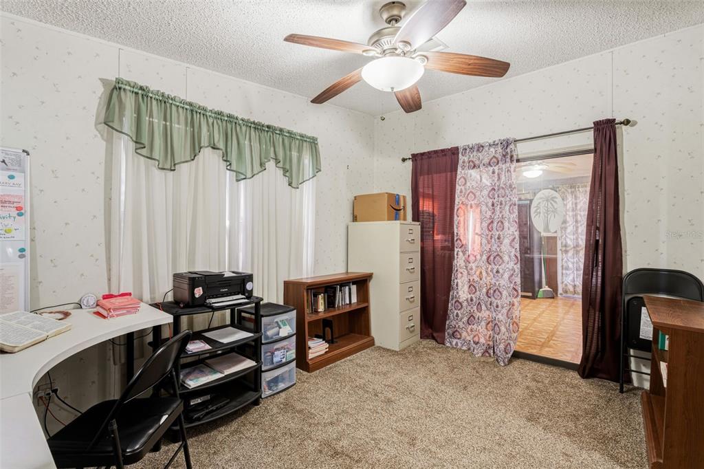 1586 Grapefruit Street Arcadia, FL 34266 - Photo 27 of 40 a living room with furniture and a chandelier