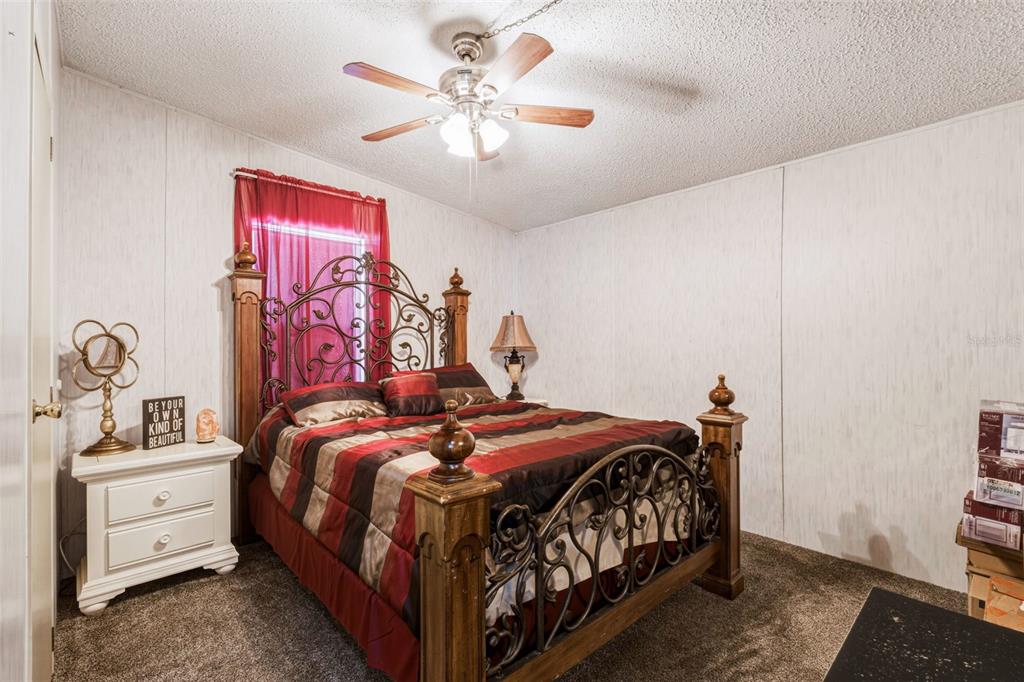 1586 Grapefruit Street Arcadia, FL 34266 - Photo 29 of 40 a bedroom with a bed and a chandelier