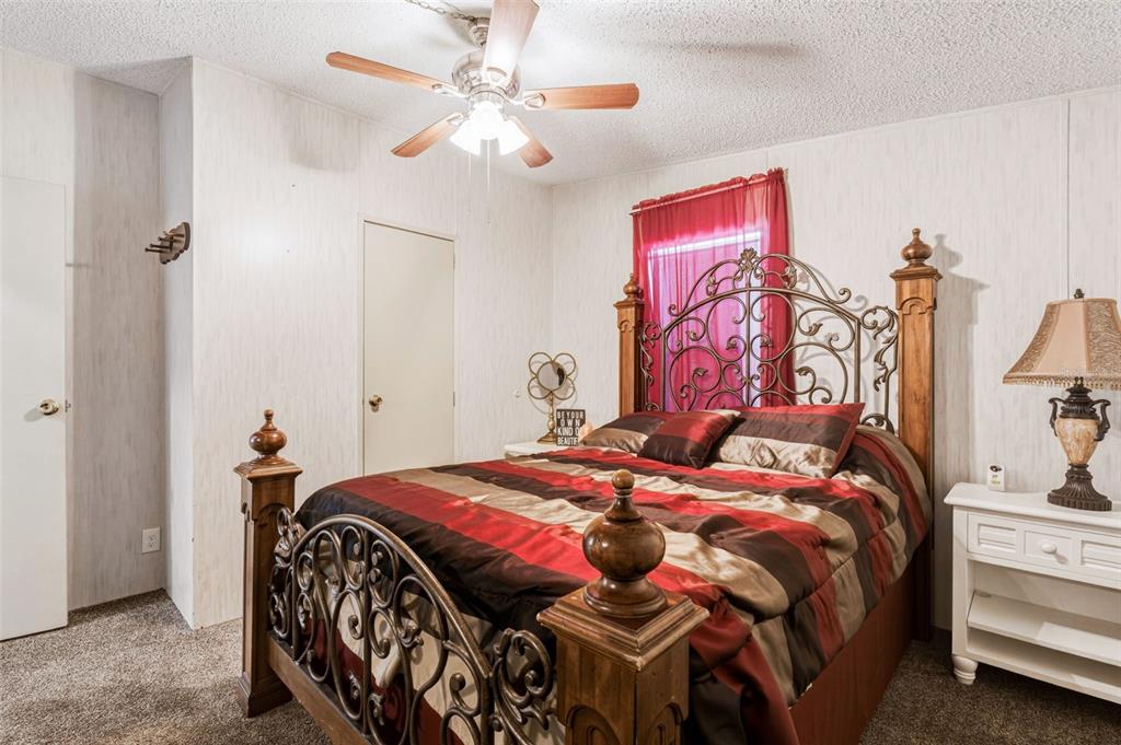 1586 Grapefruit Street Arcadia, FL 34266 - Photo 30 of 40 a bedroom with a bed and a chandelier