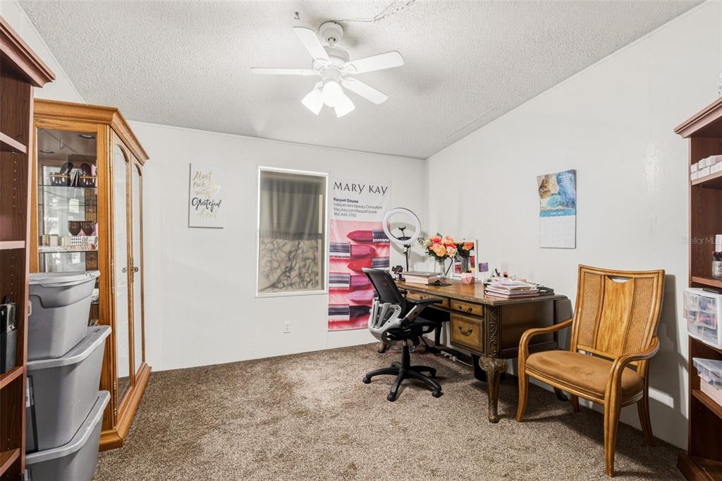 1586 Grapefruit Street Arcadia, FL 34266 - Photo 32 of 40 a view of a workspace with furniture and a chandelier fan