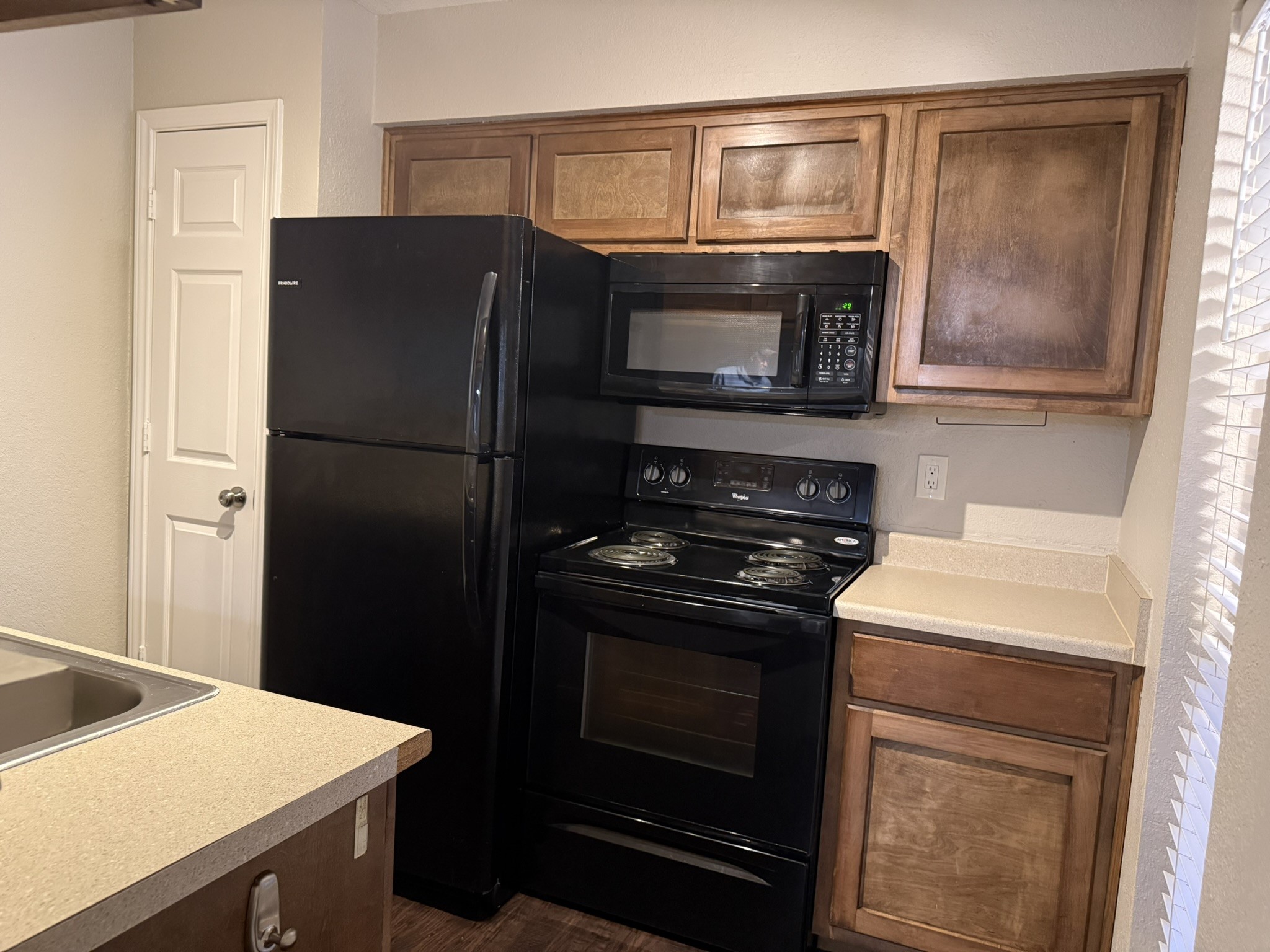 16303 Lyons School Road, Unit 304 Spring, TX 77379 - Photo 10 of 17 a kitchen with a stove microwave and refrigerator