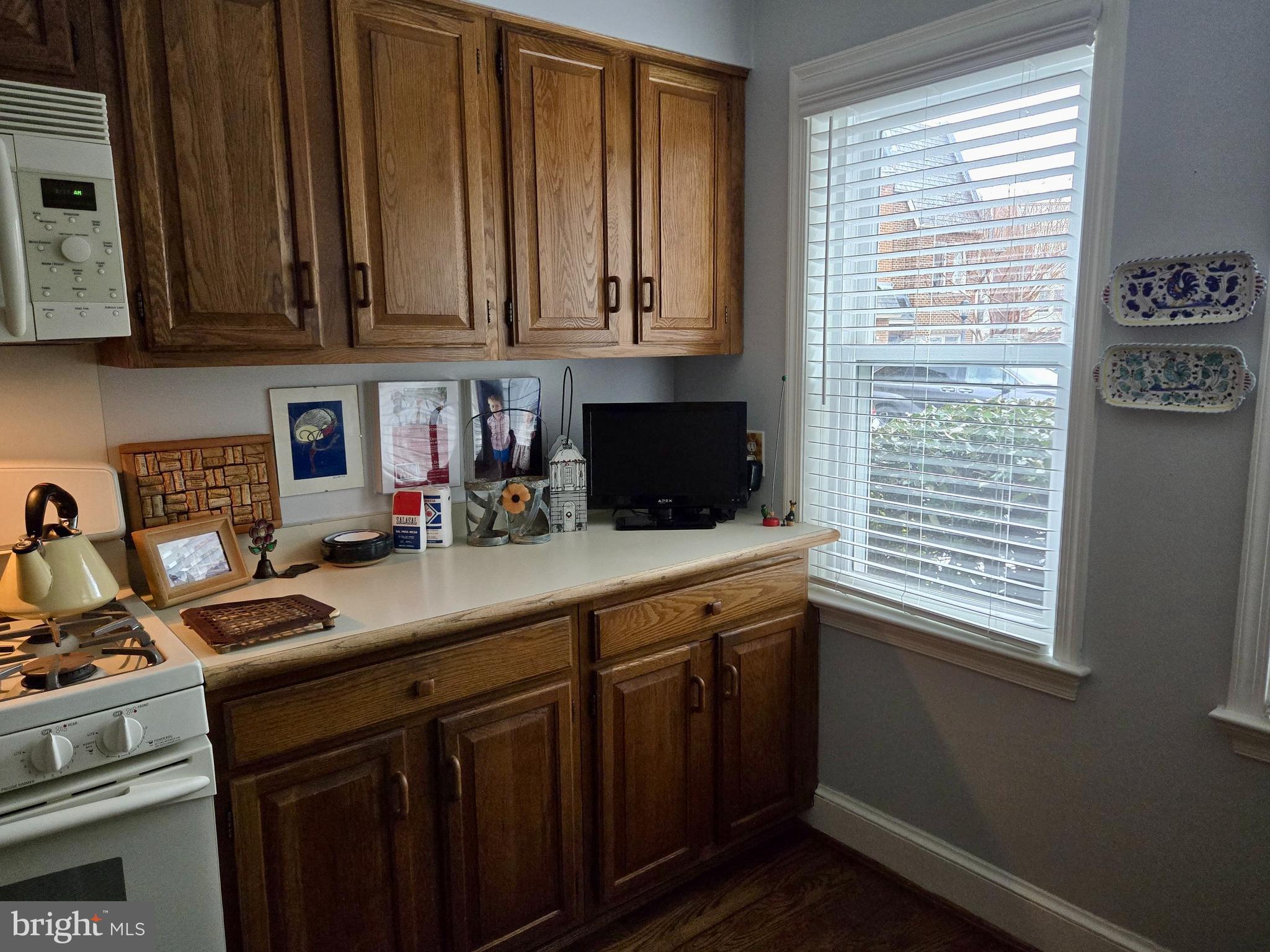 4416 Lingan Road Northwest Washington, DC 20007 - Photo 11 of 59 a kitchen with stainless steel appliances granite countertop a sink a stove and cabinets