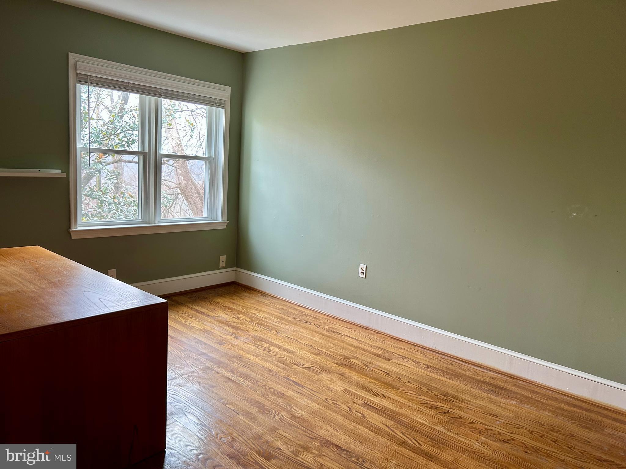 4416 Lingan Road Northwest Washington, DC 20007 - Photo 18 of 59 an empty room with wooden floor and a window