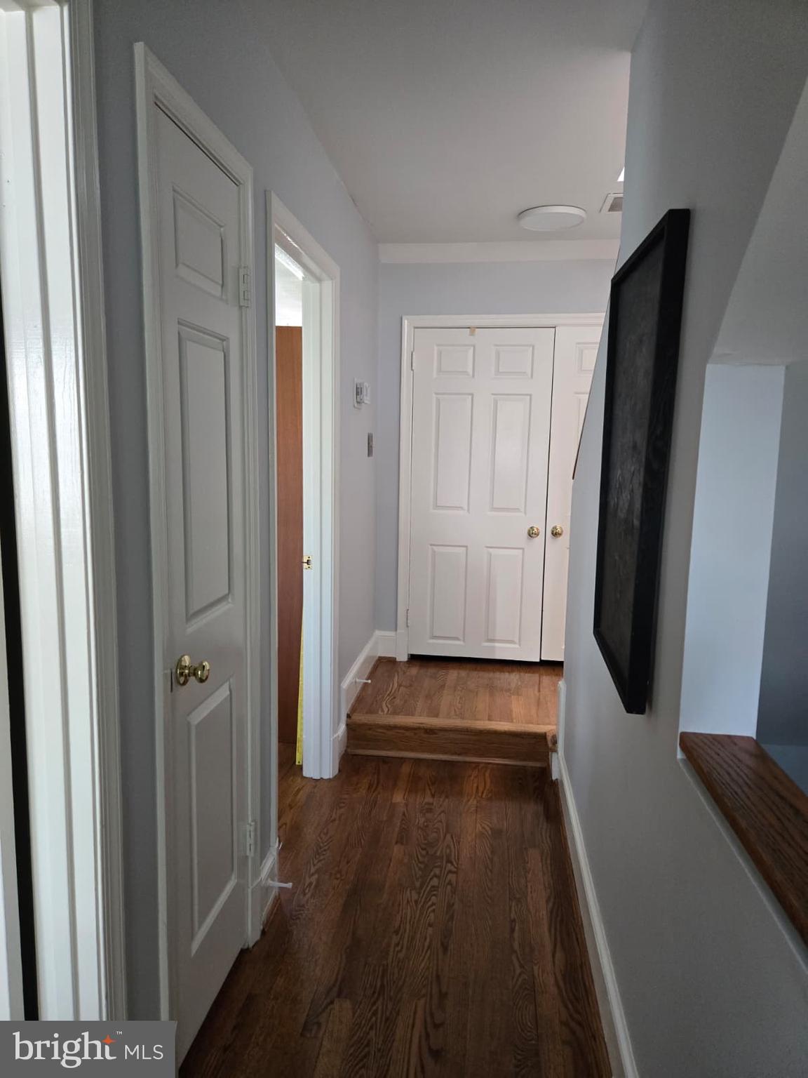 4416 Lingan Road Northwest Washington, DC 20007 - Photo 22 of 59 a hallway with white doors wooden floor and stairs