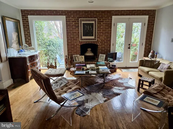 a living room with furniture fireplace and a large window