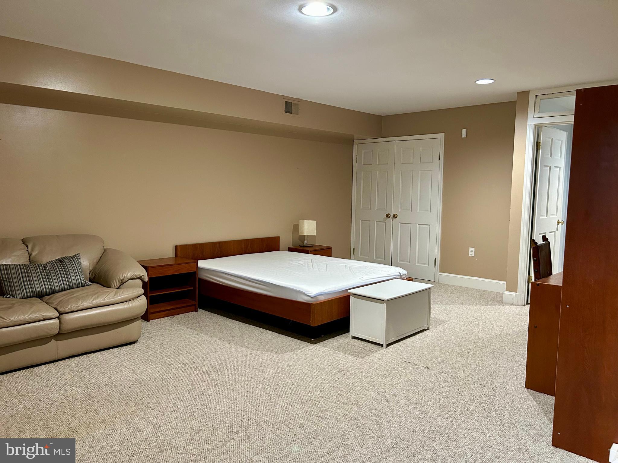 4416 Lingan Road Northwest Washington, DC 20007 - Photo 50 of 59 a living room with a couch and a refrigerator