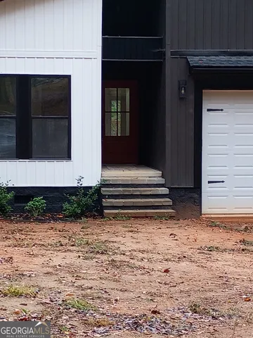 a living room with furniture and a mirror