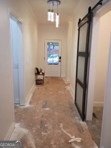 a view of a livingroom with furniture and a hallway