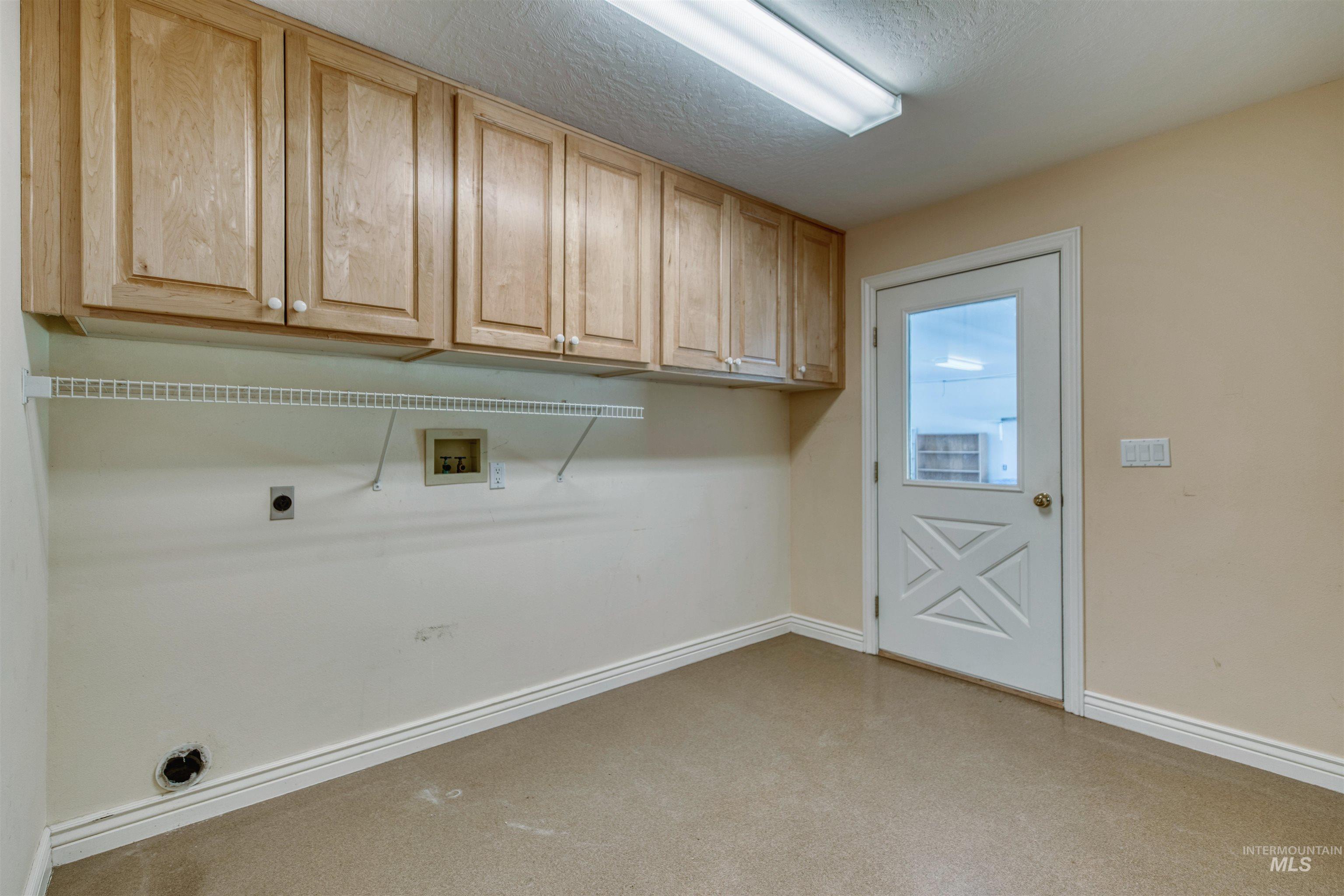 1295 15th Street Vale, OR 97918 - Photo 13 of 50 Laundry room featuring washer hookup, a textured ceiling, hookup for an electric dryer, and cabinet space