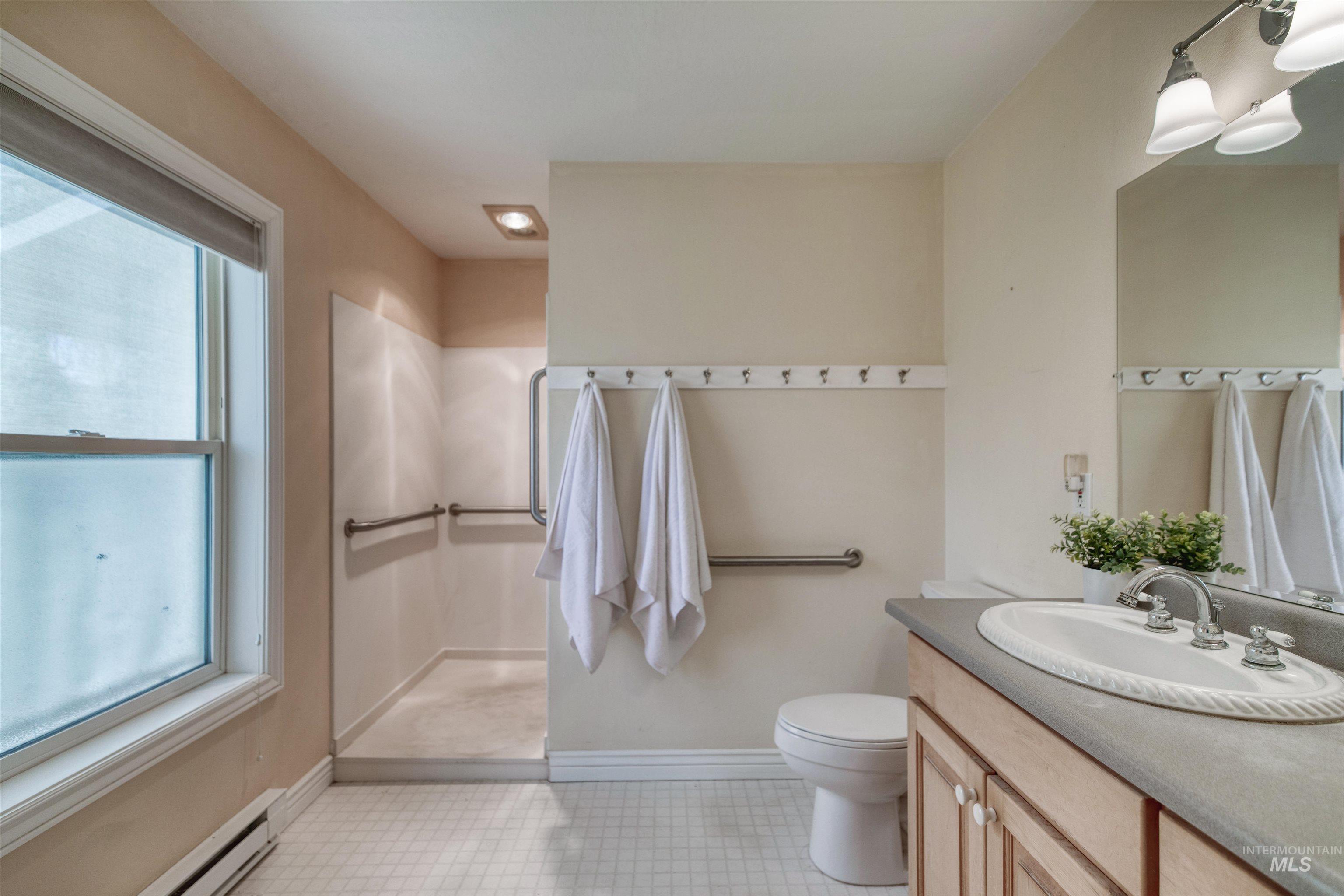 1295 15th Street Vale, OR 97918 - Photo 17 of 50 Full bath with vanity, a baseboard radiator, and a walk in shower