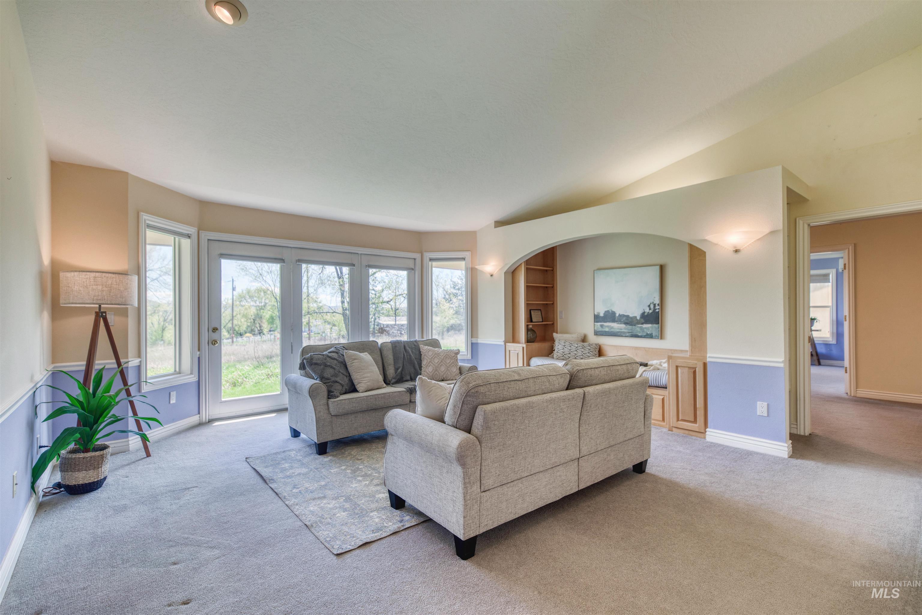 1295 15th Street Vale, OR 97918 - Photo 2 of 50 Living room featuring built in features, light colored carpet, and vaulted ceiling
