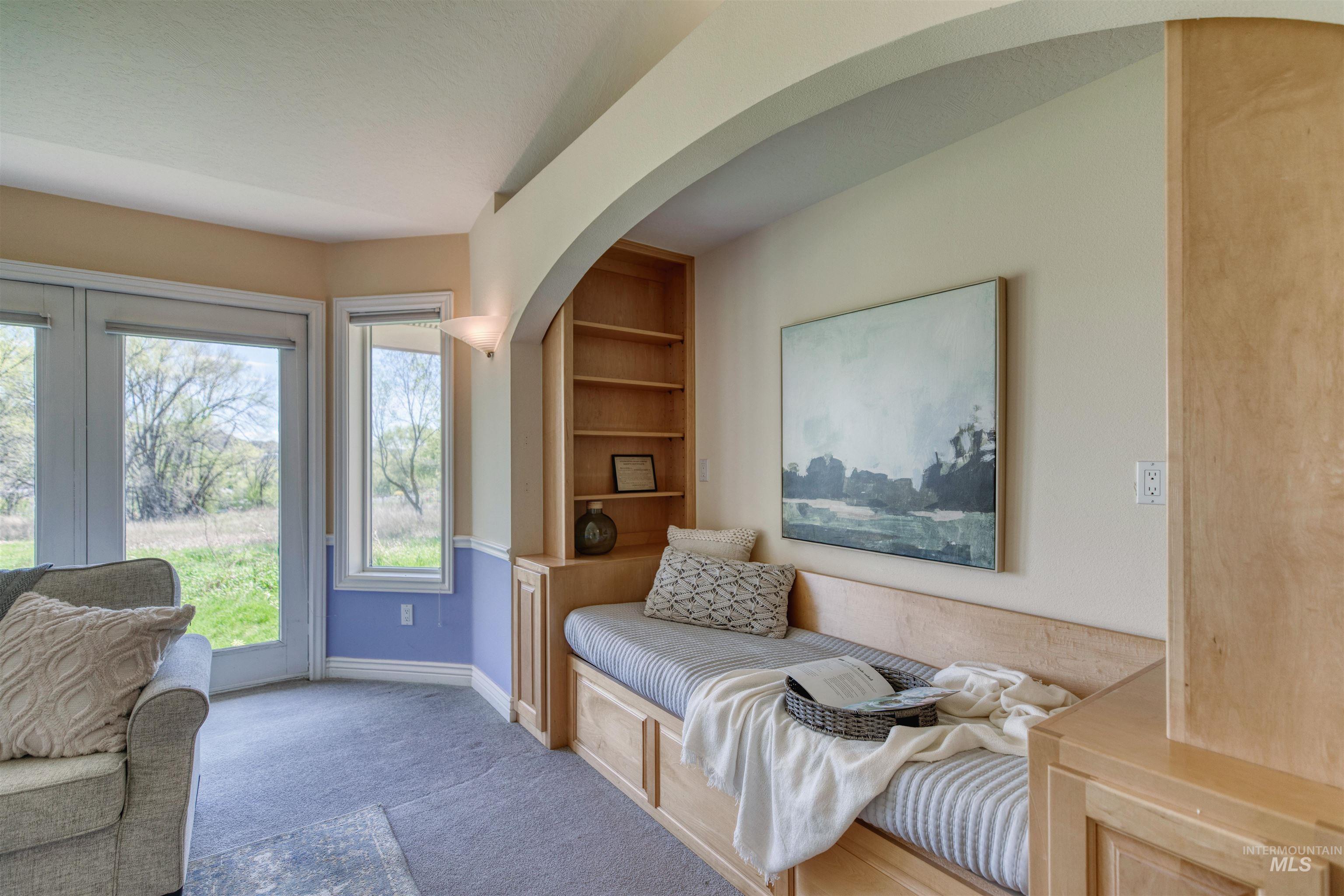 1295 15th Street Vale, OR 97918 - Photo 22 of 50 Living area with built in shelves, carpet, and arched walkways