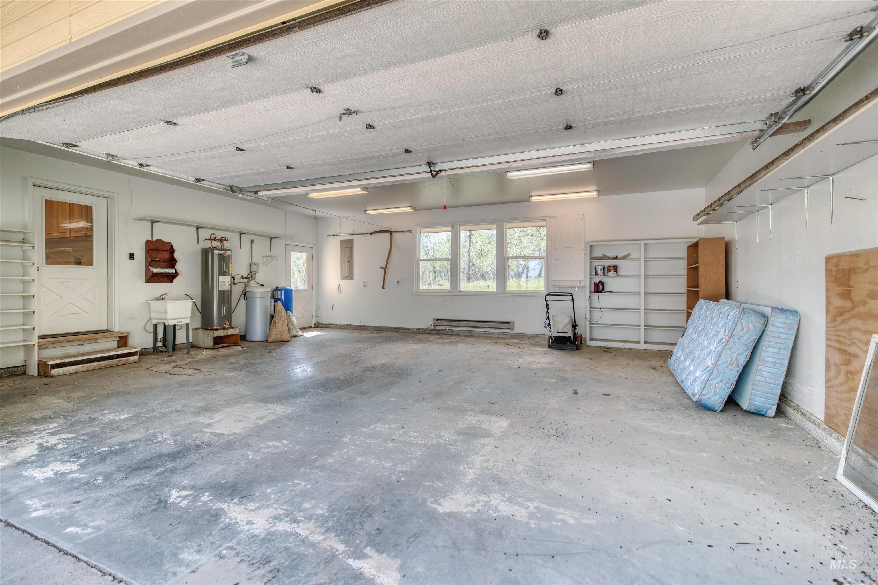 1295 15th Street Vale, OR 97918 - Photo 26 of 50 Garage with electric water heater and a sink