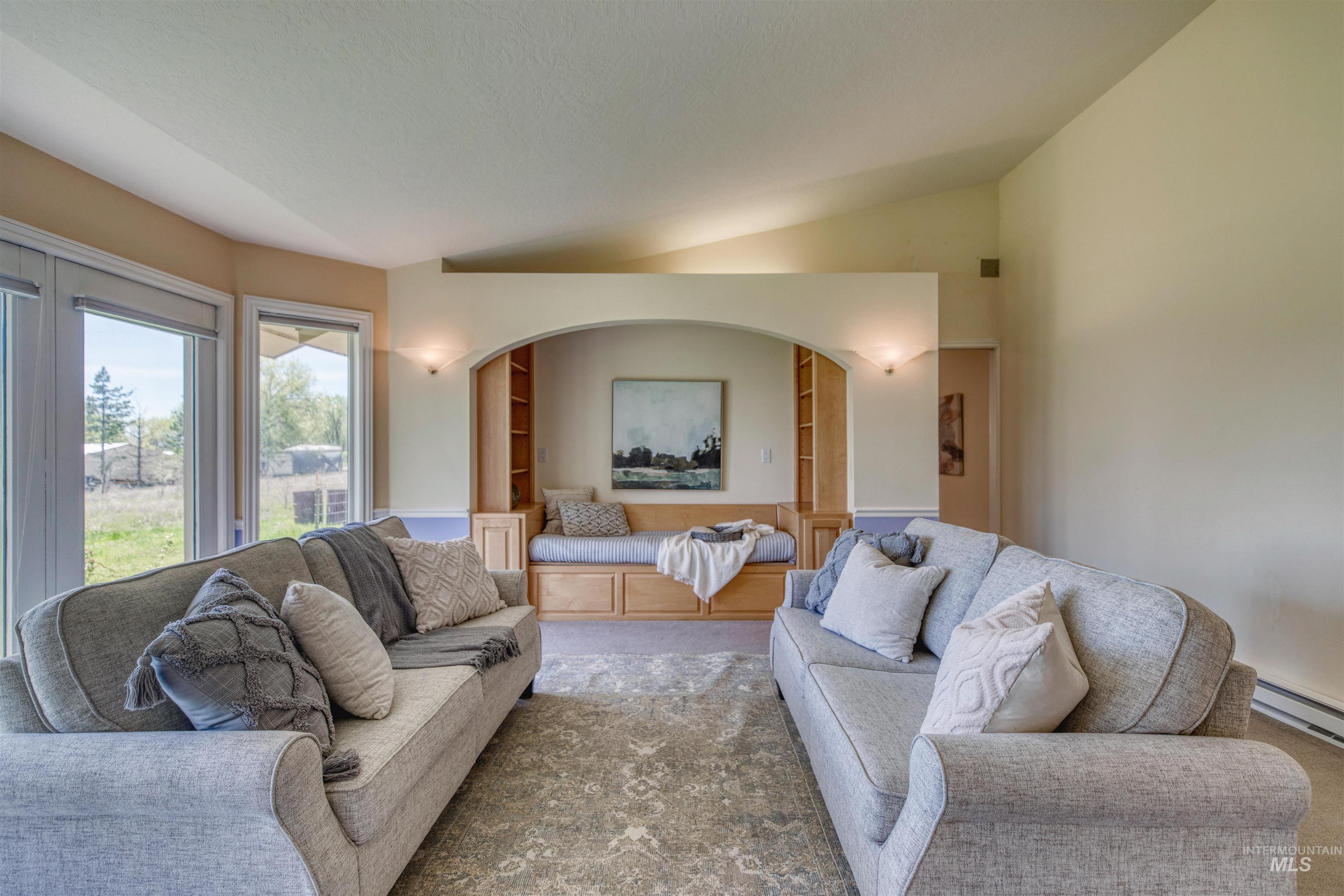 1295 15th Street Vale, OR 97918 - Photo 3 of 50 Living room with lofted ceiling, built in features, and carpet floors