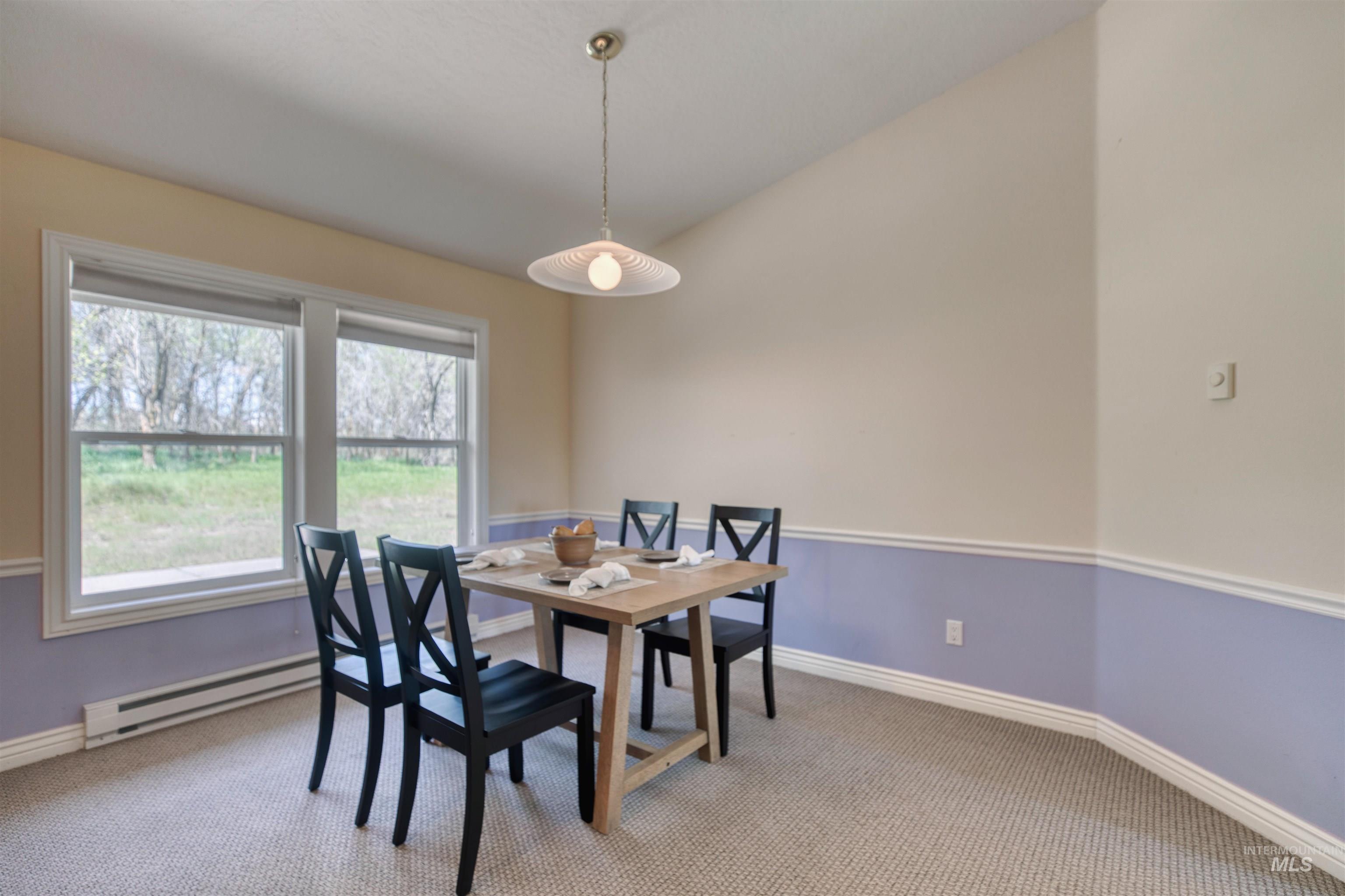 1295 15th Street Vale, OR 97918 - Photo 7 of 50 Dining area with light colored carpet and baseboard heating