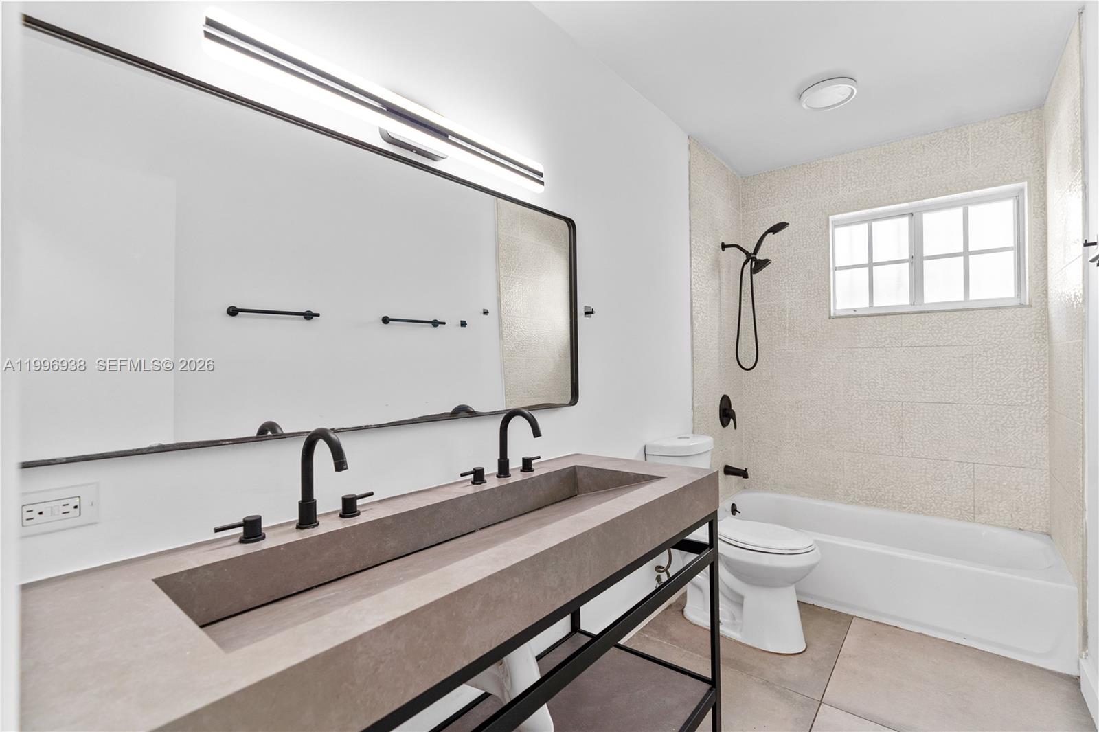 361 East 39th Street, Unit 1 Hialeah, FL 33013 - Photo 11 of 47 a bathroom with a tub sink and mirror