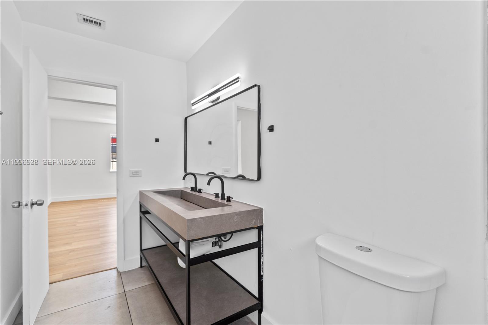 361 East 39th Street, Unit 1 Hialeah, FL 33013 - Photo 12 of 47 a bathroom with a sink a toilet and mirror