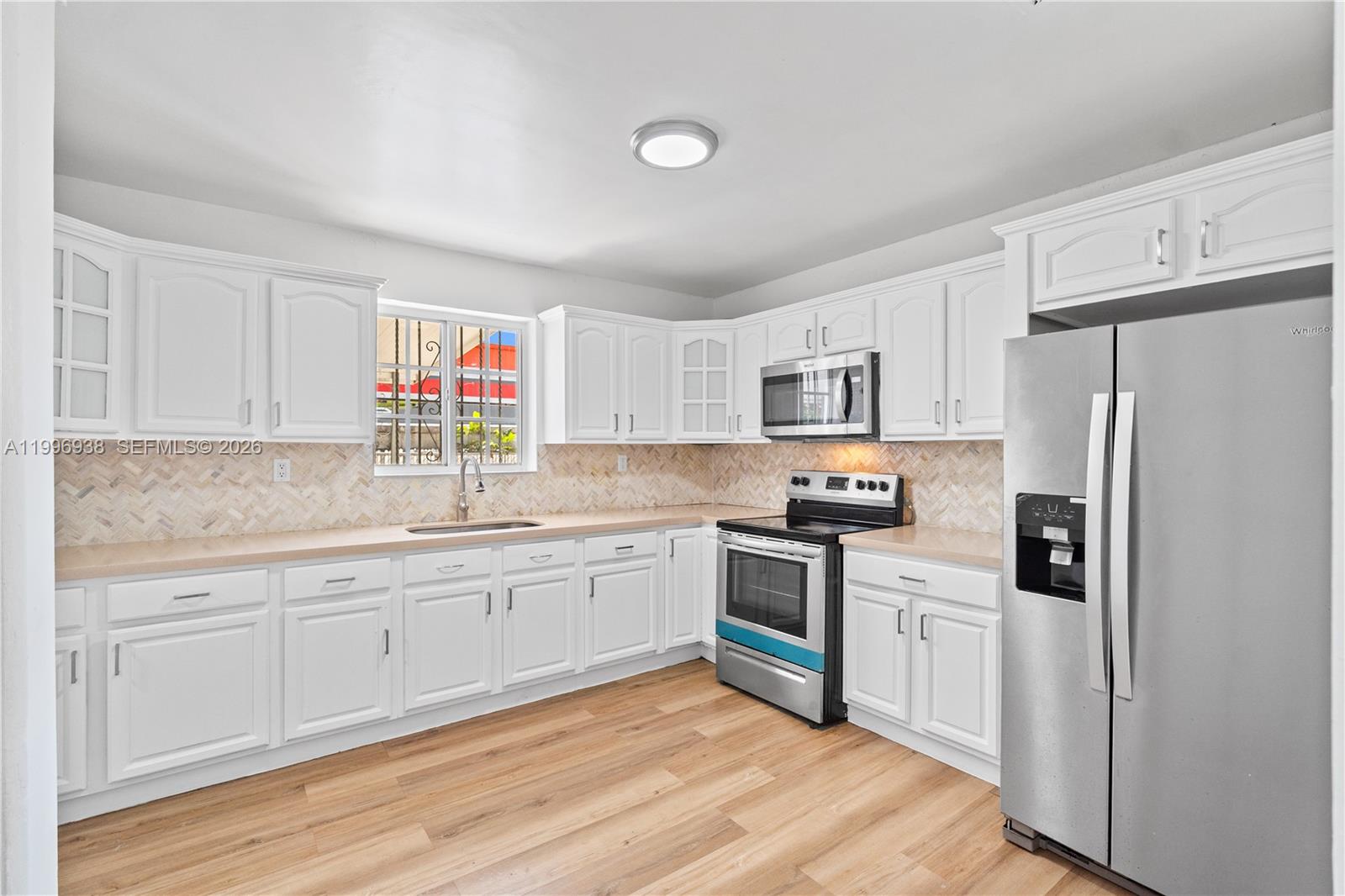 361 East 39th Street, Unit 1 Hialeah, FL 33013 - Photo 17 of 47 a kitchen with stainless steel appliances granite countertop a refrigerator sink and stove