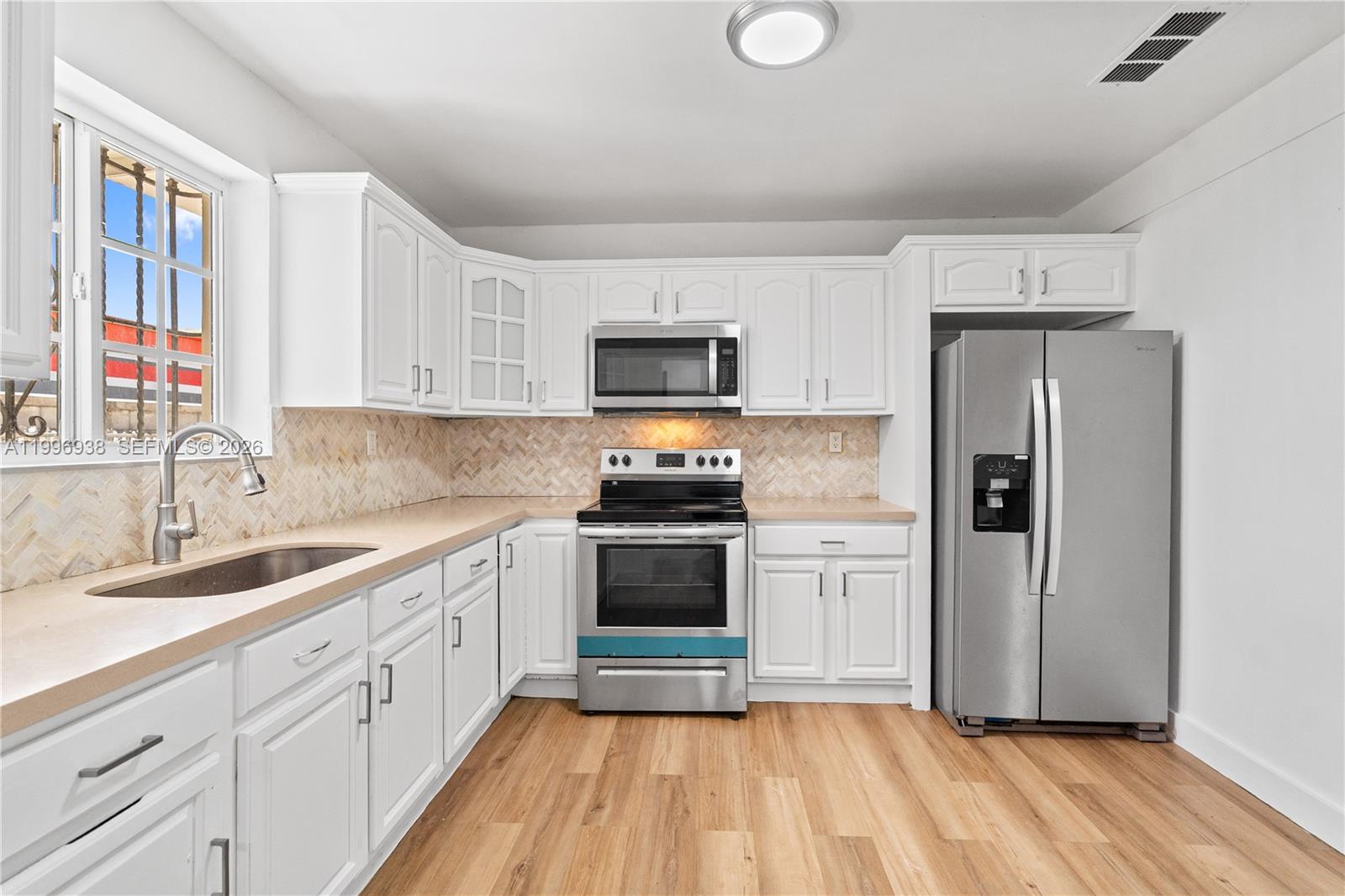 361 East 39th Street, Unit 1 Hialeah, FL 33013 - Photo 19 of 47 a kitchen with granite countertop a refrigerator and a sink