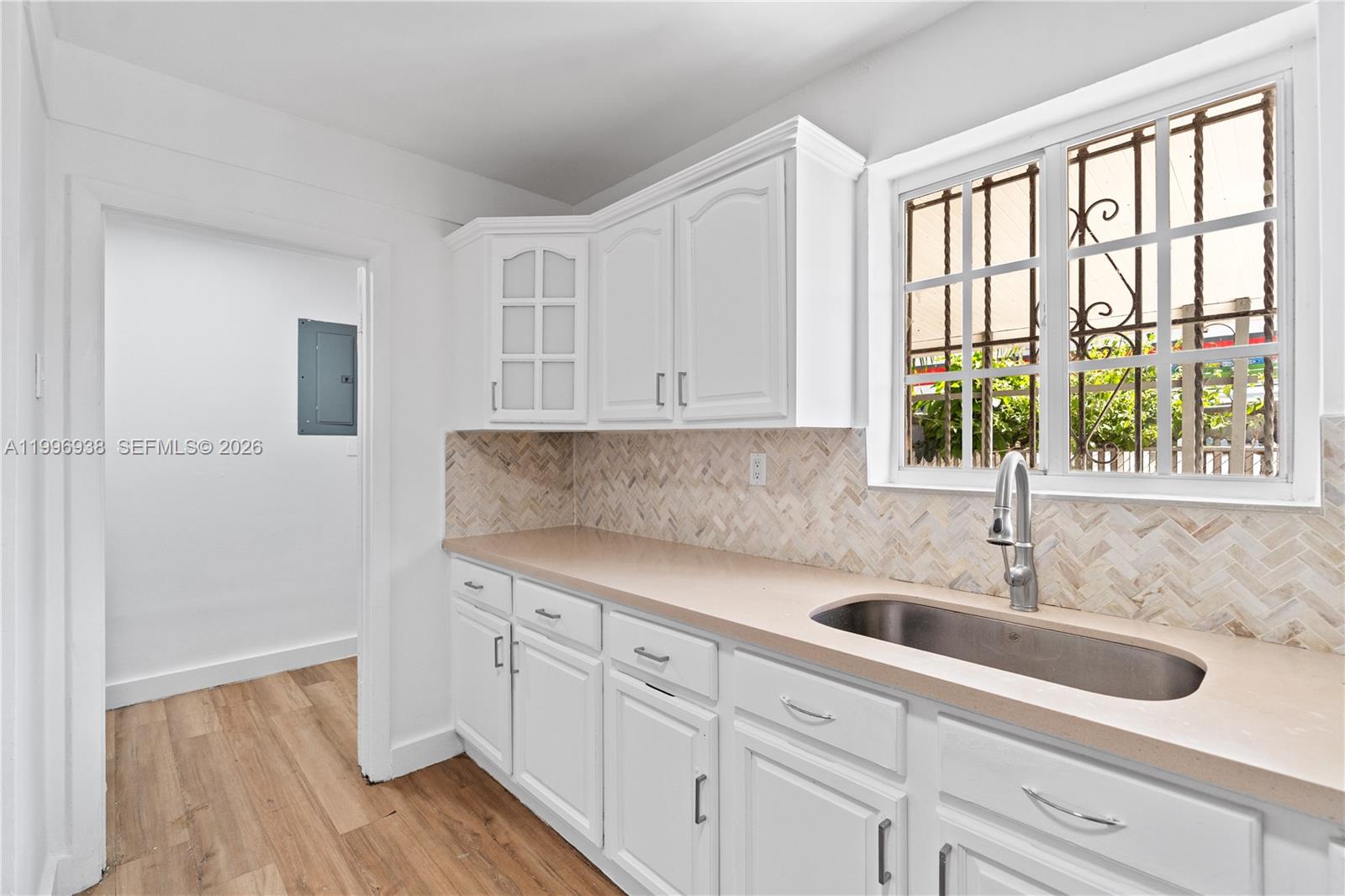 361 East 39th Street, Unit 1 Hialeah, FL 33013 - Photo 20 of 47 a kitchen with stainless steel appliances granite countertop a sink and wooden cabinets